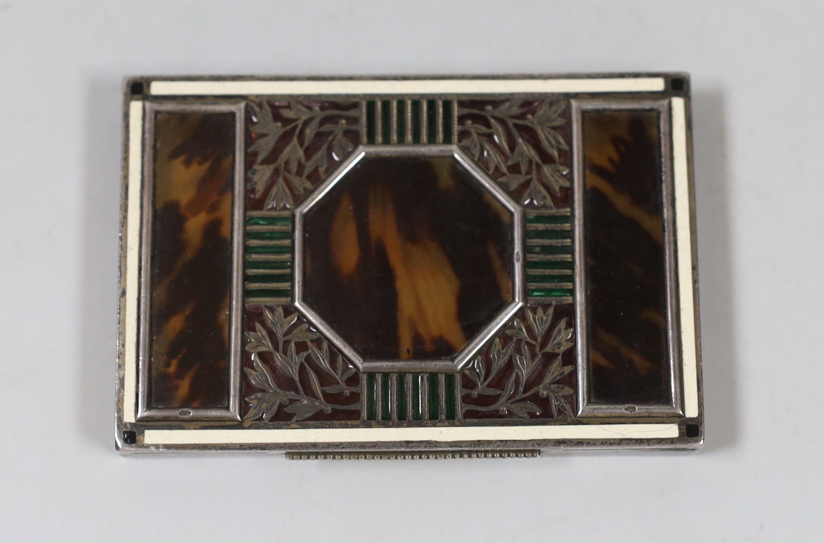 A 1920's Austrian 935S white metal, tortoiseshell, enamel and plique a jour cigarette case, import marks for London, 1927, 87mm, retailed by Holmes & Co?.